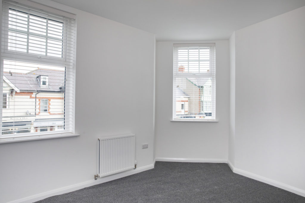 White empty bedroom with two windows from our new Conwy Road development