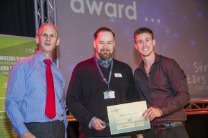 Jason Webster wins award with Andrew Bowden our Chief Executive and Ash Dykes at our Colleague Conference 2016 at Venue Cymru